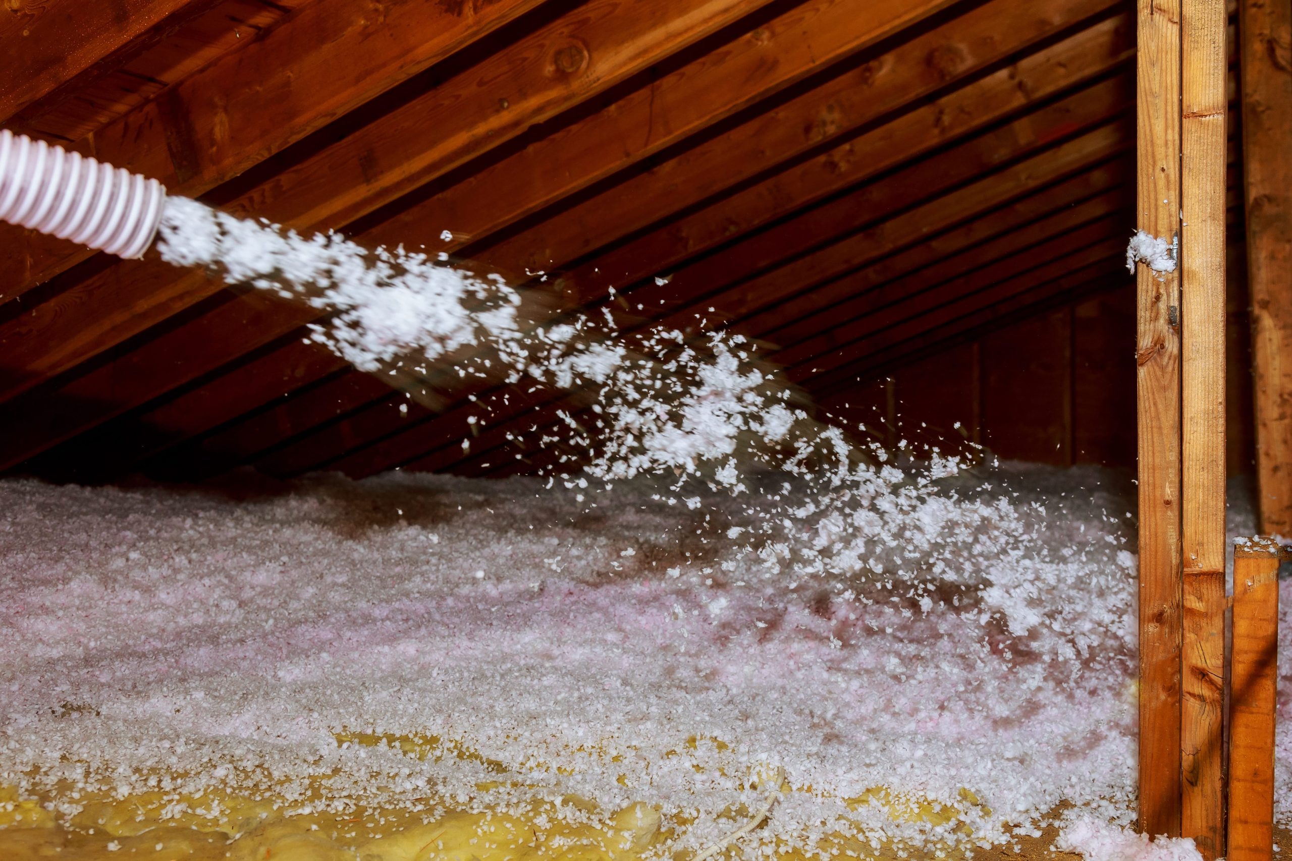 blow in insulation being blown in through hose