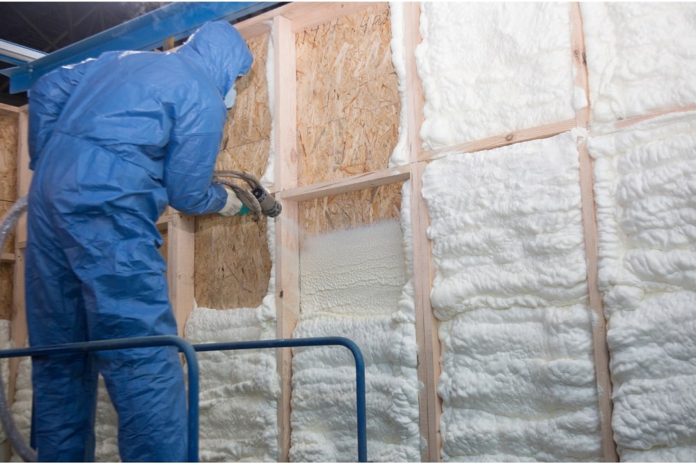 man installing spray foam insulation