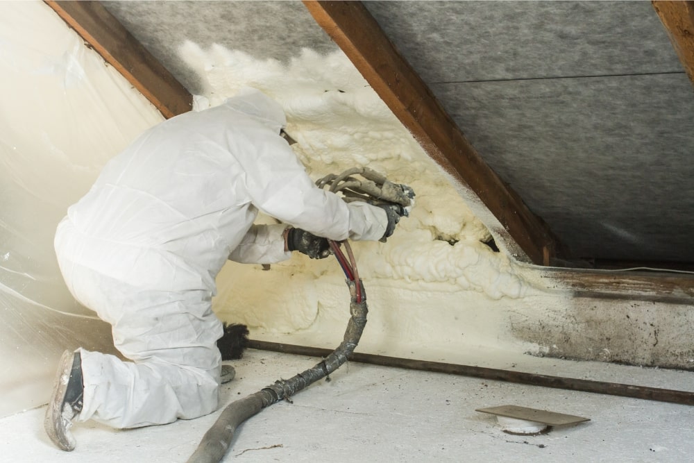 man spraying spray foam insulation