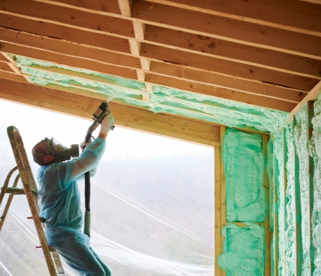 man installing spray foam insulation
